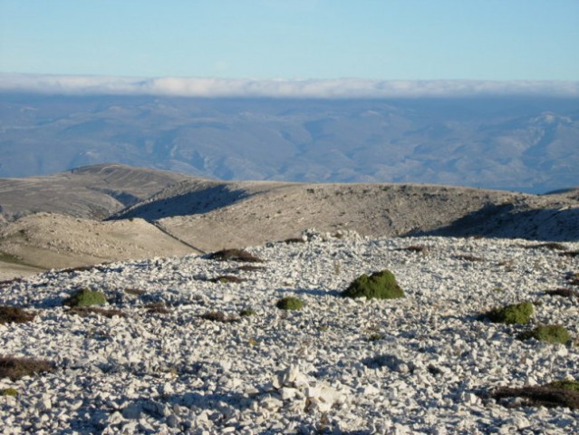Pogled z vrha preko kamnite puščave otoka Krka do Velebita..